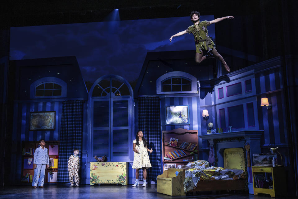 This image released by Bond Theatrical shows Nolan Almeida as Peter Pan, top right, and, from left, Micah Turner Lee as John, Reed Epley as Michael and Hawa Kamara as Wendy, during a performance of an inclusive stage production of “Peter Pan.” The touring production kicks off in Maryland on Feb. 21 and travels to North Carolina, Ohio, Illinois, Washington, D.C., South Carolina, Florida, Arizona, Nevada, California, Missouri, Texas and Georgia. (Matthew Murphy/Bond Theatrical via AP)
