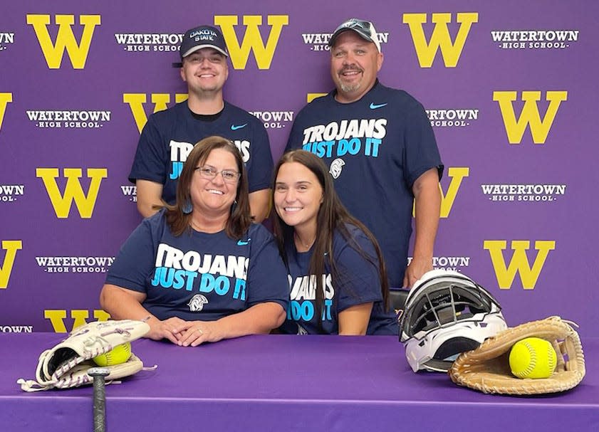 Grace Ortmeier (front right), a 2022 Watertown High School graduate, has signed to play college softball at Dakota State University in Madison. Also pictured are her mother Cris (front left), brother Alex (back left) and father Shane (back right). Ortmeier competed in tennis, basketball and track and field at WHS and has played softball with the Roy's Sport Shop Force, Brookings Outlaws and Yankton Fury. Her combined stats with three teams include a .495 batting average, .881 on-base percentage and seven homers. Although primarily a catcher-first baseman, she has played all nine positions on the field. Ortmeier plans to study elementary education at DSU.