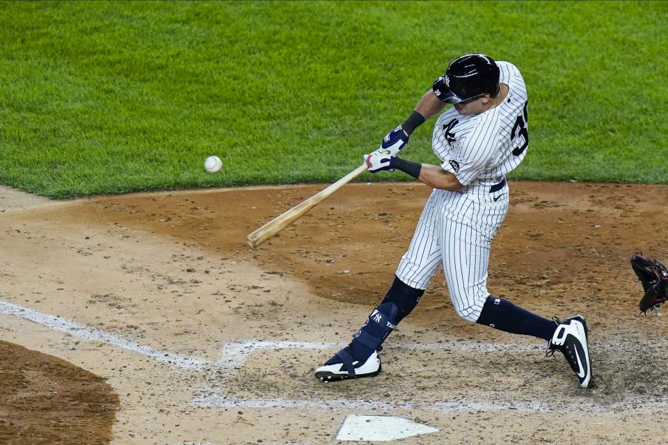 New York Yankees' Mike Tauchman hits an RBI double during the fifth inning of a baseball game against the Boston Red Sox Friday, Aug. 14, 2020, in New York. (AP Photo/Frank Franklin II)