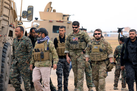 FILE PHOTO: Syrian Democratic Forces and U.S. troops are seen during a patrol near Turkish border in Hasakah, Syria November 4, 2018. REUTERS/Rodi Said