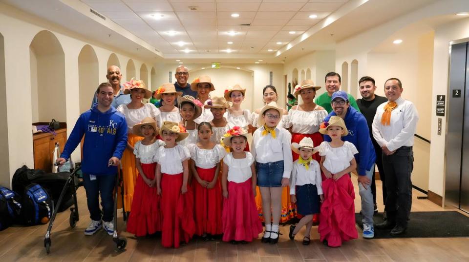 Royals infield coach José Alguacil (back middle) takes a picture with performers at Guadalupe Centers’ Cinco de Mayo festival Saturday. Fresco Marketing