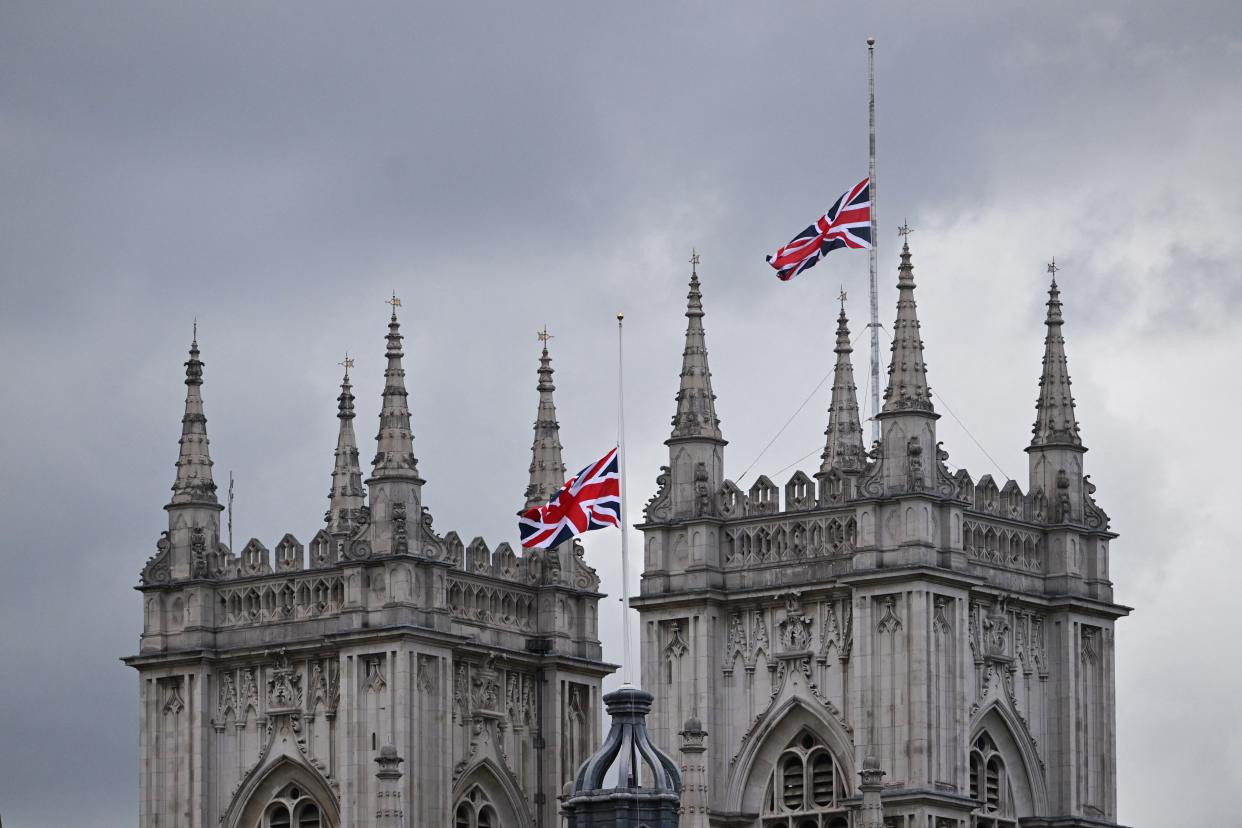 TOPSHOT - The Union Jack flag flies half mast at Westminster Abbey in London on September 15, 2022, following the death of Britain's Queen Elizabeth II on September 8. - Queen Elizabeth II will lie in state until 0530 GMT on September 19, a few hours before her funeral, with huge queues expected to file past her coffin to pay their respects. (Photo by SEBASTIEN BOZON / AFP) (Photo by SEBASTIEN BOZON/AFP via Getty Images)
