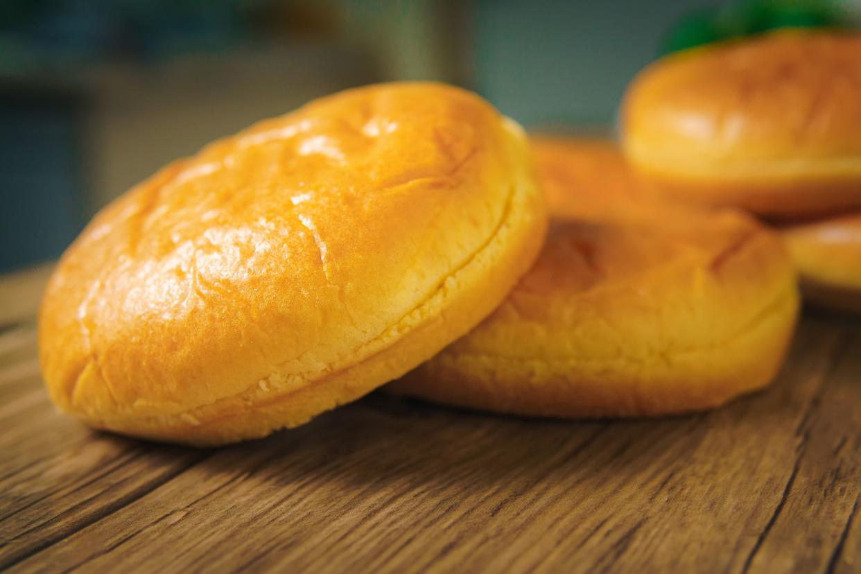 Two hamburger buns with sesame seeds isolated in a kitchen, empty hamburger buns, homemade sweet Brioche Hamburger Buns ready to eat