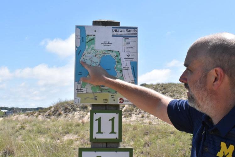 Aaron Bodbyl-Mast of Ottawa County shows where the campgrounds will be located on a map of Ottawa Sands County Park.