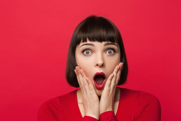 Woman in red looking amazed