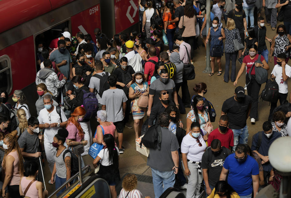 Commuters wear protective face masks as they walk through a subway station, in Sao Paulo, Brazil, Wednesday, Dec. 1, 2021, amid the COVID-19 pandemic. Brazil joined the widening circle of countries to report cases of the omicron variant. (AP Photo/Andre Penner)