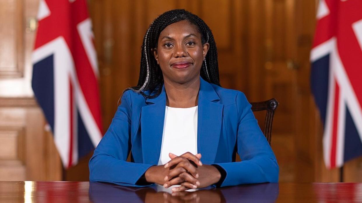 Kemi Badenoch sitting at a table