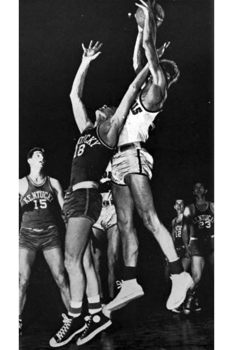 This photo provided by Saint Louis University Archives shows Saint Louis forward Joe Ossola grabbing a rebound over Kentucky's Dale Barnstable (18) in the second half of an NCAA college basketball game at the Sugar Bowl tournament in New Orleans, Dec. 30, 1948. Saint Louis beat Kentucky 42-40. When the first AP Top 25 men's college basketball poll was published in January 1949, Saint Louis was installed at No. 1 ahead of mighty Kentucky, thanks to a head-to-head win a few weeks earlier in New Orleans. (Photo Courtesy of Saint Louis University Archives via AP)