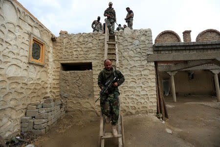 Afghan Special Forces walk down from a roof of a house which was used by suspected Islamic State militants at the site of a MOAB, or ''mother of all bombs'', that struck the Achin district of the eastern province of Nangarhar, Afghanistan April 23, 2017. REUTERS/Parwiz