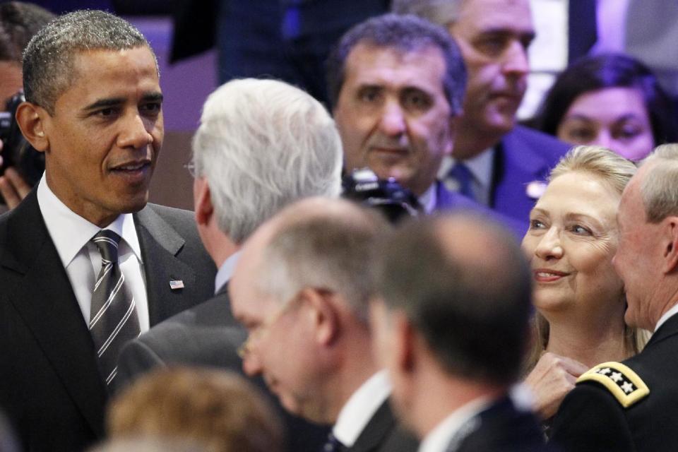 President Barack Obama and Secretary of State Hillary Rodham Clinton mingle before the meeting on Afghanistan during the NATO Summit, Monday, May 21, 2012, in Chicago. (AP Photo/Carolyn Kaster)