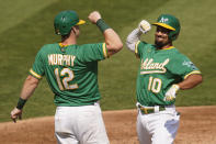 Oakland Athletics' Marcus Semien (10) celebrates after hitting a two-run home run that scored Sean Murphy (12) against the Chicago White Sox during the second inning of Game 2 of an American League wild-card baseball series Wednesday, Sept. 30, 2020, in Oakland, Calif. (AP Photo/Eric Risberg)