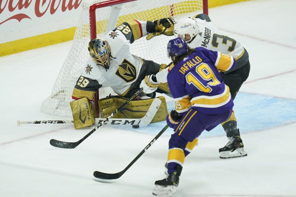 Vegas Golden Knights goaltender Marc-Andre Fleury (29) and defenseman Brayden McNabb block a shot by Los Angeles Kings right wing Alex Iafallo (19) during the first period of an NHL hockey game Wednesday, April 14, 2021, in Los Angeles. (AP Photo/Ashley Landis)