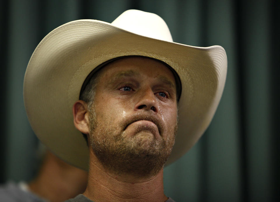 Tyson Houston, nephew of Cliven Bundy, cries after speaking at a public meeting in the Moapa Valley Community Center in Overton, Nev. Wednesday, April 9, 2014. The meeting was about the roundup by the Bureau of Land Management's roundup of what they call "trespass cattle" run by Cliven Bundy in the Gold Butte area 80 miles northeast of Las Vegas. (AP Photo/Las Vegas Review-Journal, John Locher)