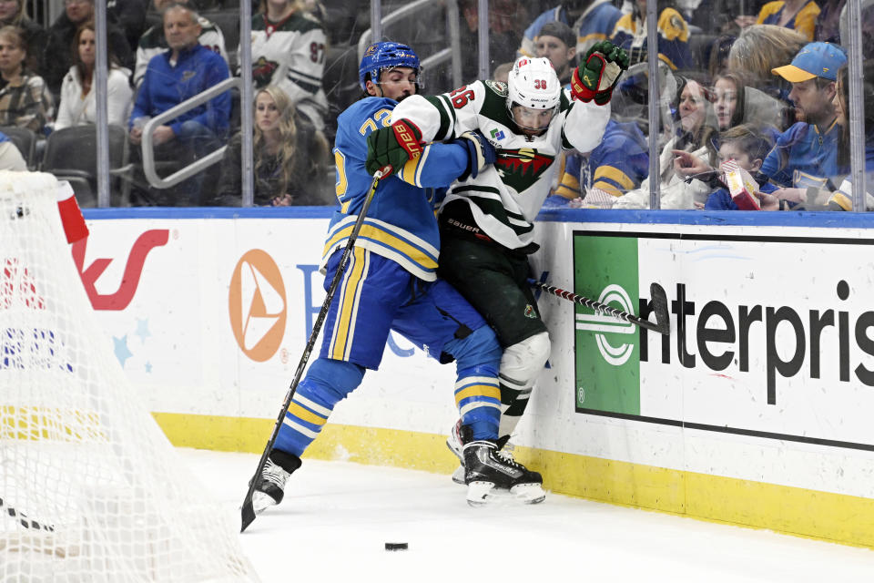 Minnesota Wild Mats Zuccarello (36) fight for the puck against St. Louis Blues' Justin Faulk (72) during the first period an NHL hockey game on Saturday, March 2, 2024, in St. Louis. (AP Photo/Michael Thomas)