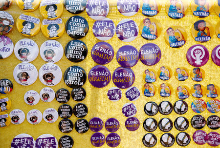 Buttons reading "#NotHim" and "Fight like a girl" are seen for sale during a demonstration against Brazil's presidential candidate Jair Bolsonaro, in Sao Paulo, Brazil September 29, 2018. REUTERS/Alexandre Schneider