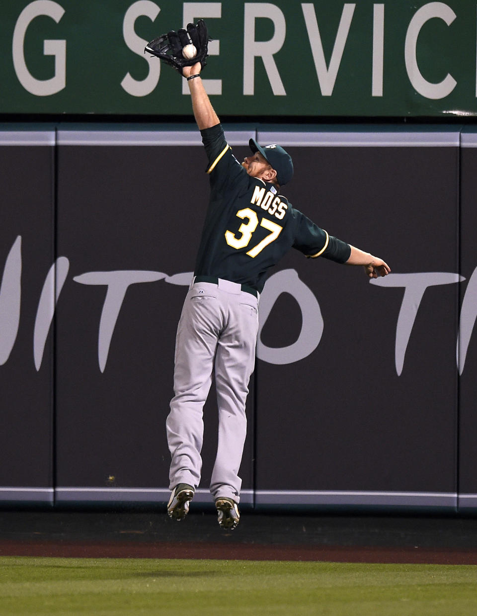 Oakland Athletics first baseman Brandon Moss makes a catch on a fly ball hit by Los Angeles Angels' Howie Kendrick during the seventh inning of a baseball game, Wednesday, April 16, 2014, in Anaheim, Calif. (AP Photo/Mark J. Terrill)