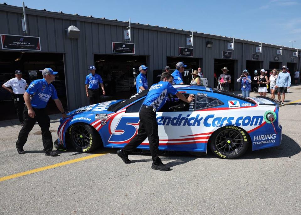 Jun 16, 2024; Newton, Iowa, USA; The team of NASCAR Cup Series driver Kyle Larson (5) rolls his car to pit crew at Iowa Speedway.