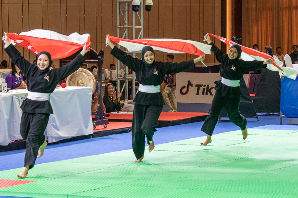 Singapore's women's artistic silat team of Amirah Sahrin, Iffah Batrisyia Noh and Ashikin Zulkifli celebrate winning the gold medal. (PHOTO: SportSG/Flona Hakim)