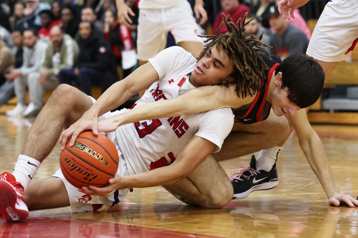 Bridgewater-Raynham's Cason Faulk and Whitman-Hanson's Dylan Perrault go after a loose ball during a game on Thursday, Dec. 21, 2023. Bridgewater-Raynham won the game in double overtime 75-72.