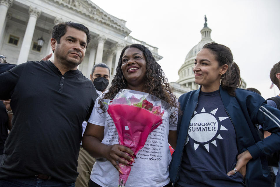 From left, Rep. Jimmy Gomez, D-Calif., Rep. Cori Bush, D-Mo., and Rep. Alexandria Ocasio-Cortez, D-N.Y., embrace each other after it was announced that the Biden administration will enact a targeted nationwide eviction moratorium outside of Capitol Hill in Washington on Tuesday, August 3, 2021. For the past five days, lawmakers and activists primarily led by Rep. Cori Bush, D-Mo., have been sitting in on the steps of Capitol Hill to protest the expiration of the eviction moratorium. (AP Photo/Amanda Andrade-Rhoades)