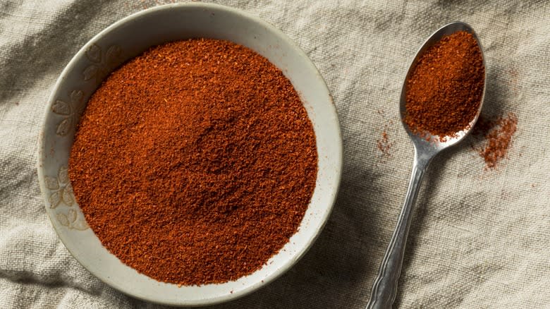 Top down view of bowl and spoon of smoked paprika