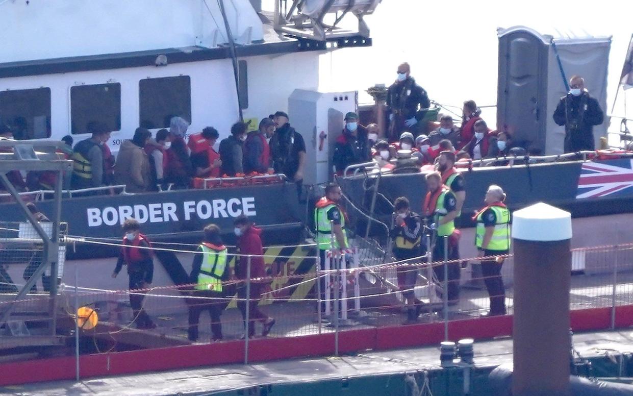 A group of people thought to be migrants are brought in to Dover, Kent