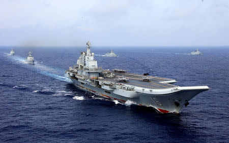 FILE PHOTO: China's aircraft carrier Liaoning takes part in a military drill of Chinese People's Liberation Army (PLA) Navy in the western Pacific Ocean, April 18, 2018. REUTERS/Stringer/File Photo