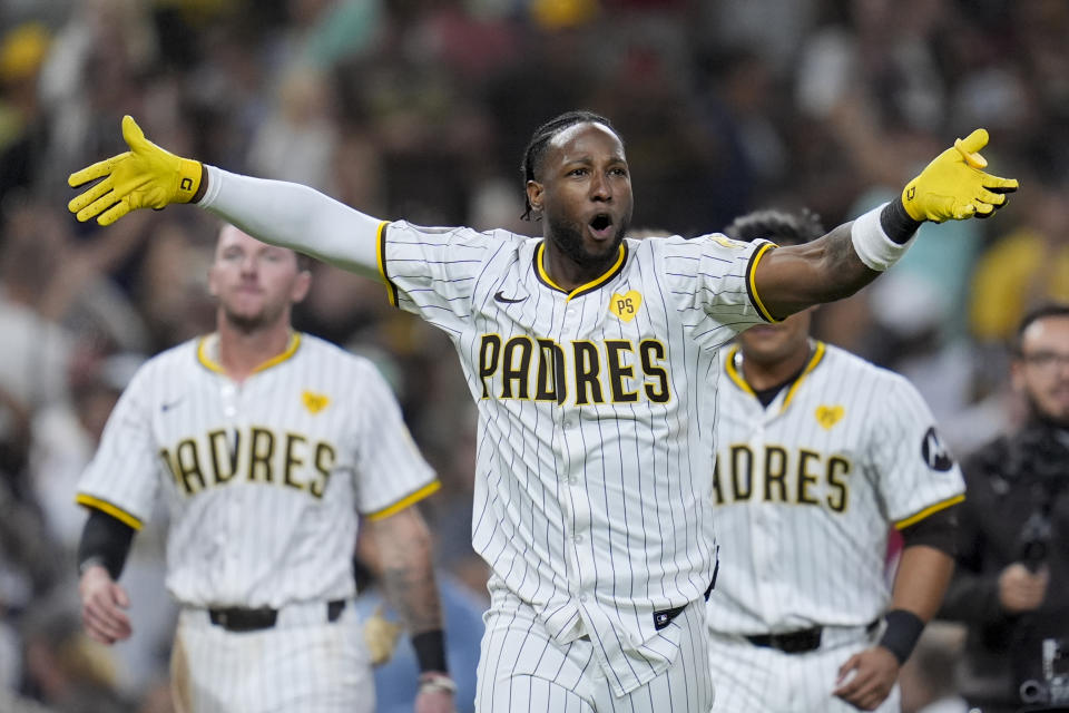 San Diego Padres' Jurickson Profar, center, celebrates after hitting a two-RBI ground rule double to defeat the Washington Nationals during the tenth inning of a baseball game Monday, June 24, 2024, in San Diego. The Padres won, 7-6. (AP Photo/Gregory Bull)