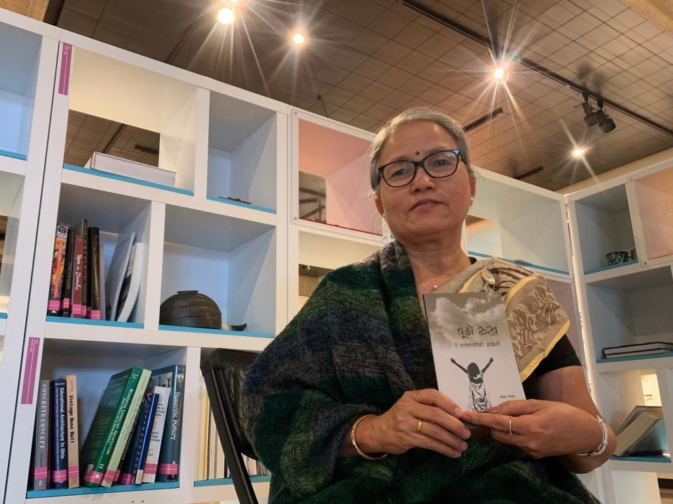 Lila Pradhan, who lives in the Cleveland area, holds a book of her poems. She is a member of the Literature Council of Bhutan and goes by the pen name Lila Nisha.