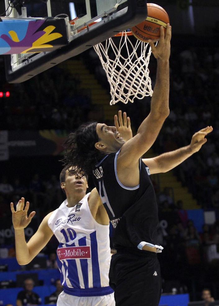 Argentina&#39;s Luis Scola, right, vies with Puerto Rico&#39;s Bryan Diaz, left, during the Group B Basketball World Cup match between Argentina and Puerto Rico in Seville, Spain, Saturday, Aug. 30, 2014. The 2014 Basketball World Cup competition will take place in various cities in Spain from Aug. 30 through to Sept. 14. (AP Photo/Miguel Angel Morenatti)