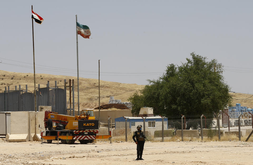 POOL - A general view of the Iraq-Iran border crossing of Mandali in northern province of Diyala, Iraq, Saturday, July, 11, 2020. Al-Kadhimi launched a campaign in the northern province of Diyala to enforce the proper payment of taxes on imported goods and recover "hundreds of millions of dollars" in revenues lost to bribery and other illicit practices. Security forces from the Interior Ministry would supervise the work of border guards in the first step of the campaign in the Mandili border crossing, he told reporters. (Thaier al-Sudani/Pool Photo via AP)