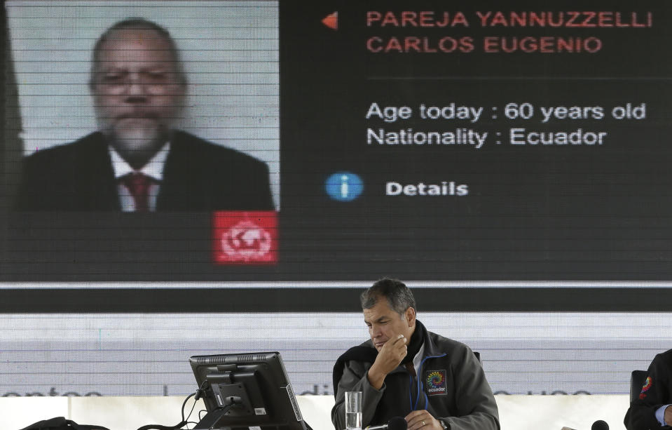 In this Feb. 4, 2017 photo, Ecuador's President Rafael Correa is backdropped by a screen displaying an image of former Oil Minister Carlos Pareja, during Correa's weekly broadcast in Quito, Ecuador. Leaked videos in which the disgraced former minister accuses Ecuador's Vice President Jorge Glas of taking part in corruption at the state-run oil company is heating up the final stretch of the country's presidential campaign. Glas is the ruling party's vice presidential candidate. (AP Photo/Dolores Ochoa)