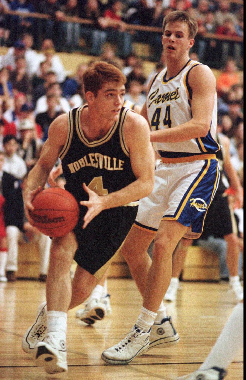 Noblesville's Tom Coverdale drives around Carmel defender Matt Abernethy during first half action at the Noblesville sectional in 1997.