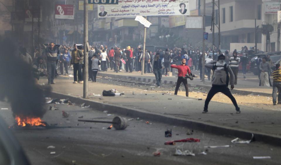 Supporters and opponents of ousted President Mursi clash at Nasr City district in Cairo