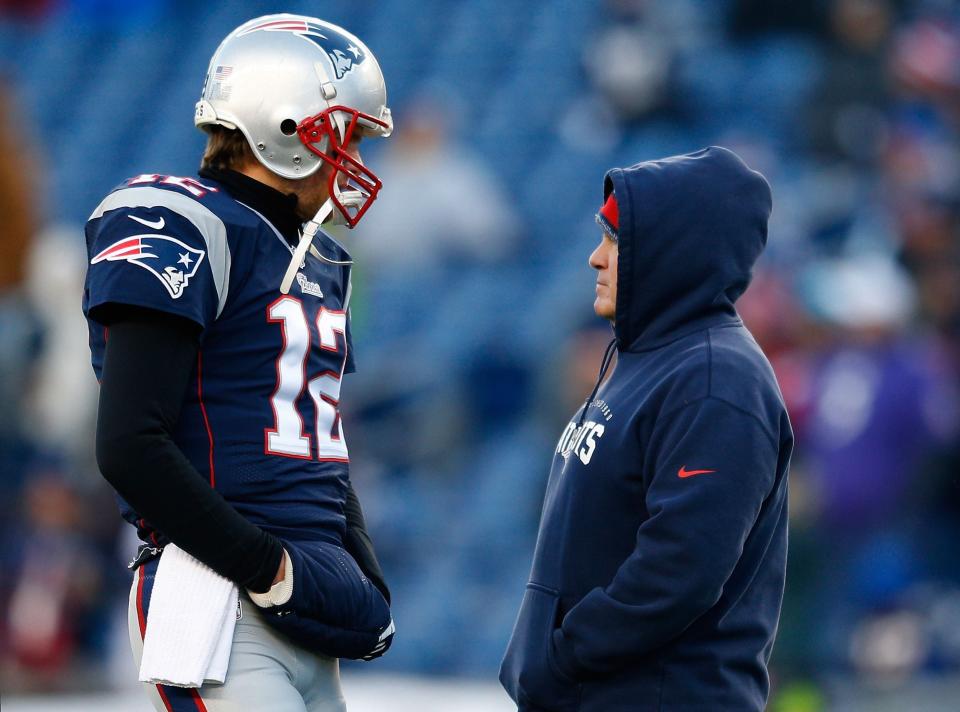 FOXBORO, MA - JANUARY 10:  Tom Brady #12 and head coach Bill Belichick of the New England Patriots talk before the 2014 AFC Divisional Playoffs game against the Baltimore Ravens at Gillette Stadium on January 10, 2015 in Foxboro, Massachusetts.  (Photo by Jim Rogash/Getty Images)