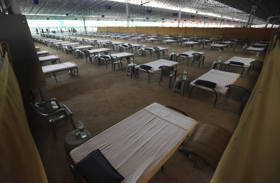 Volunteers prepare a facility that can accommodate more than ten thousand COVID-19 patients at the Radha Soami Satsang Beas complex, one of the biggest in India, in the Chattarpur area of New Delhi, India, Wednesday, June 24, 2020. New Delhi, which is among India's worst hit three states is emerging a cause of concern for the federal government and is being criticized for its poor contact tracing and a lack of enough hospital beds as India is the fourth hardest-hit country by the pandemic in the world after the U.S., Russia and Brazil. (AP Photo/Manish Swarup)