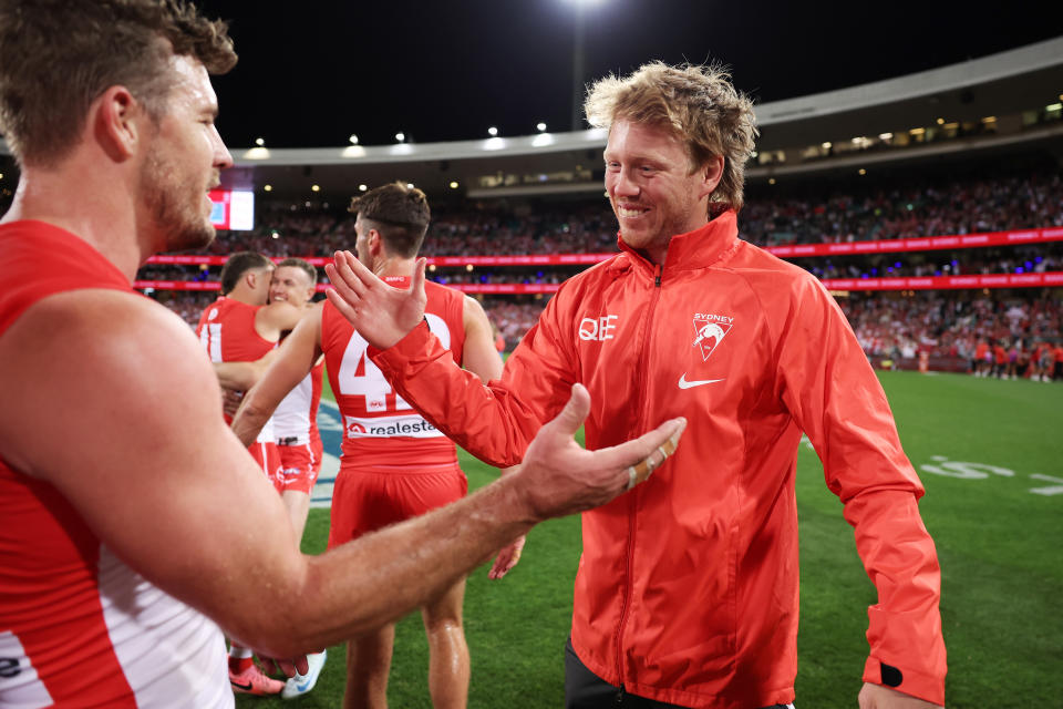 SYDNEY, AUSTRALIA - SEPTEMBER 20:  Callum Mills of the Swans celebrates victory with team mates after the AFL Preliminary Final match between Sydney Swans and Port Adelaide Power at Sydney Cricket Ground, on September 20, 2024, in Sydney, Australia. (Photo by Matt King/AFL Photos/Getty Images)