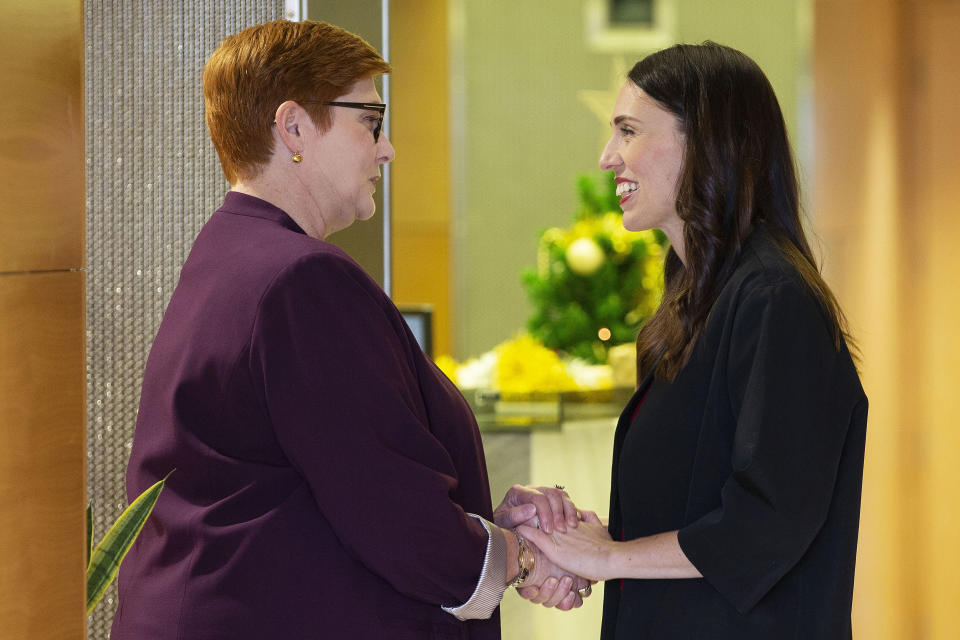 CORRECTS SPELLING TO MARISE INSTEAD OF MARISA - New Zealand Prime Minister Jacinda Ardern, right, greets Australian Foreign Minister Marise Payne in Wellington, New Zealand, Monday, Dec 16, 2019. Payne is in Wellington to thank some of the first responders who helped at the White Island volcano eruption on Dec. 9. (Hagen Hopkins/Pool Photo via AP)