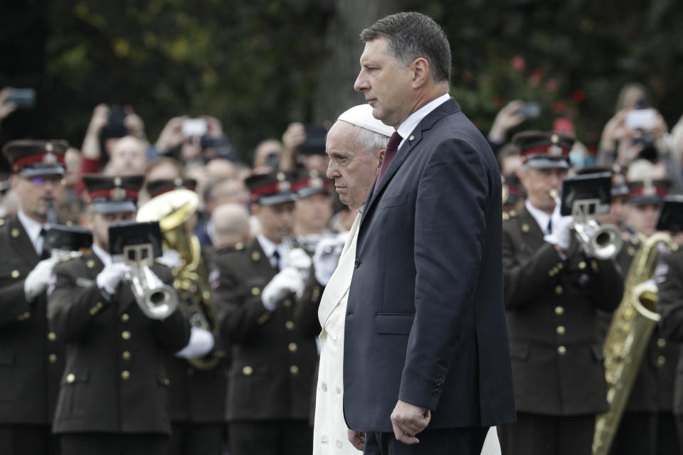 Pope Francis and Latvia President Raimonds Vejonis, right, pay homage to the Freedom monument, in Riga, Latvia, Monday, Sept. 24, 2018. Francis has travelled to the Baltic nation of Latvia to recognize its suffering under Soviet and Nazi occupation and encourage the Christian faith that endured. (AP Photo/Andrew Medichini)