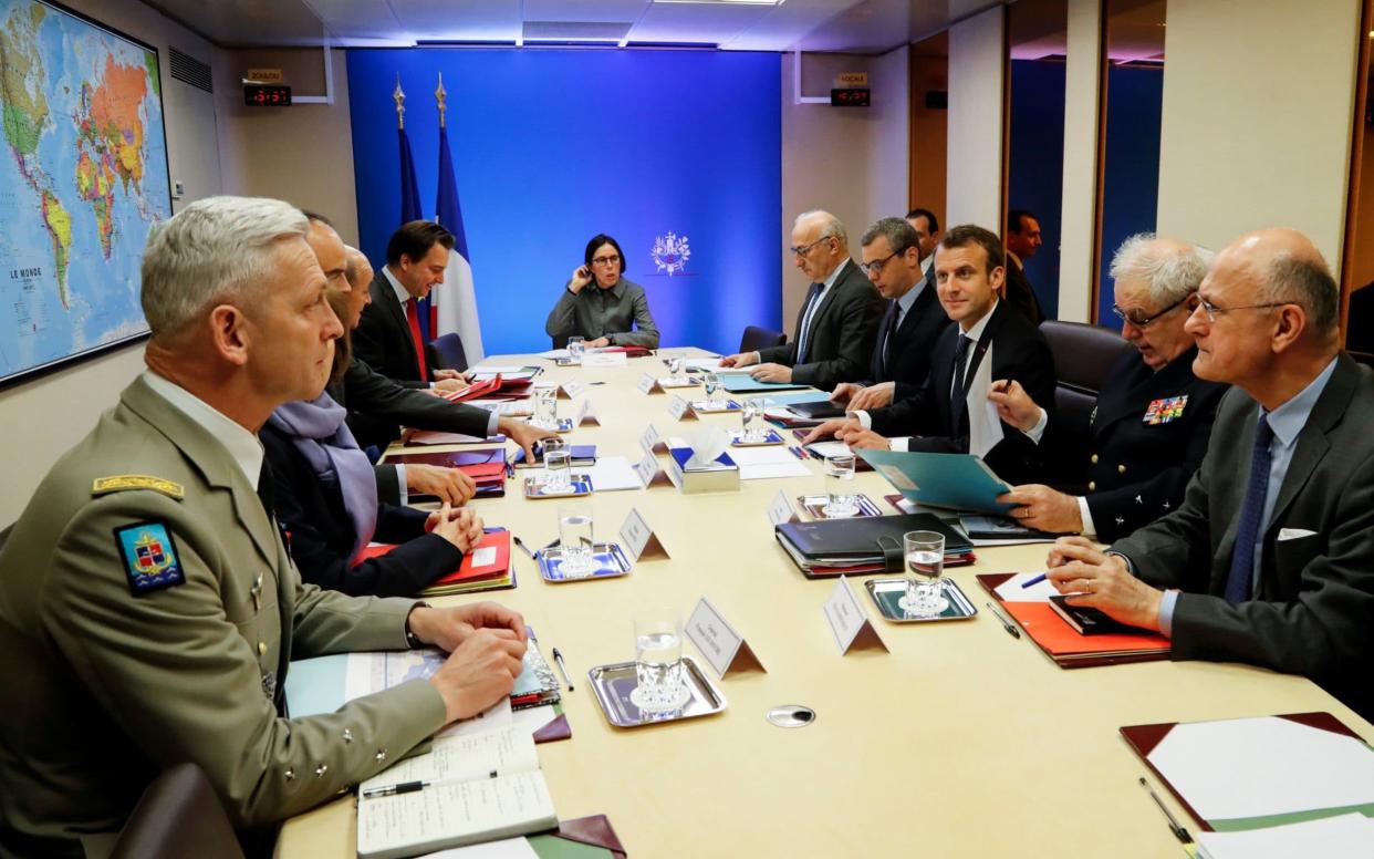 French President Emmanuel Macron (centre, right) attends a Defence Council meeting at the Elysee Palace in Paris - REUTERS