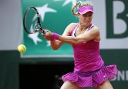 Canada's Eugenie Bouchard returns the ball to France's Kristina Mladenovic during the women's first round of the Roland Garros 2015 French Tennis Open in Paris on May 26, 2015