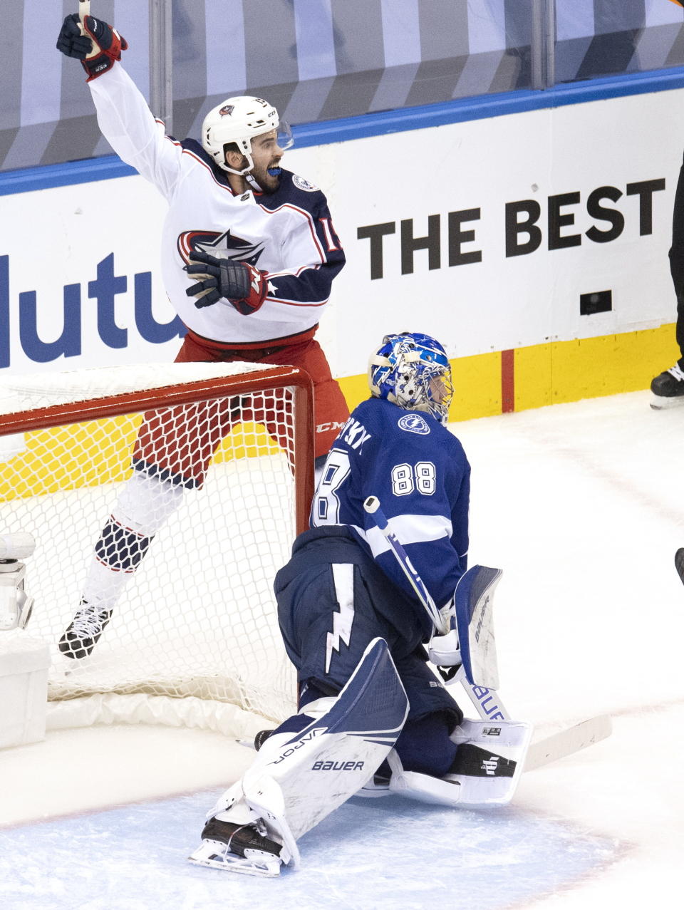 Columbus Blue Jackets center Liam Foudy (19) celebrates the goal by teammate Oliver Bjorkstrand (28) behind Tampa Bay Lightning goaltender Andrei Vasilevskiy (88) during the second period of an NHL Eastern Conference Stanley Cup first-round playoff hockey game in Toronto on Tuesday, August 11, 2020. (Frank Gunn/The Canadian Press via AP)