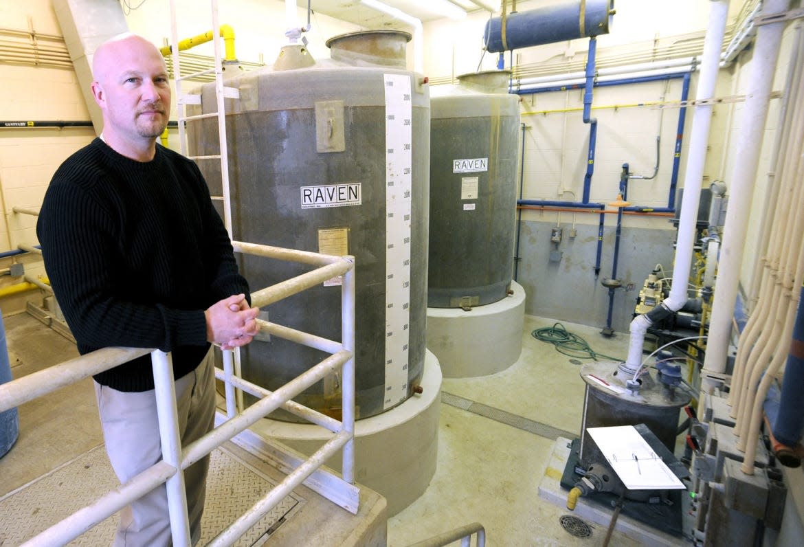 For a photograph accompanying an article on fluoride published in 2011 in The Canton Repository, Tyler Converse, superintendent of the City of Canton Water Department, stood beside bulk fluoride storage tanks at the city water department's facility on Guilford Avenue NW.