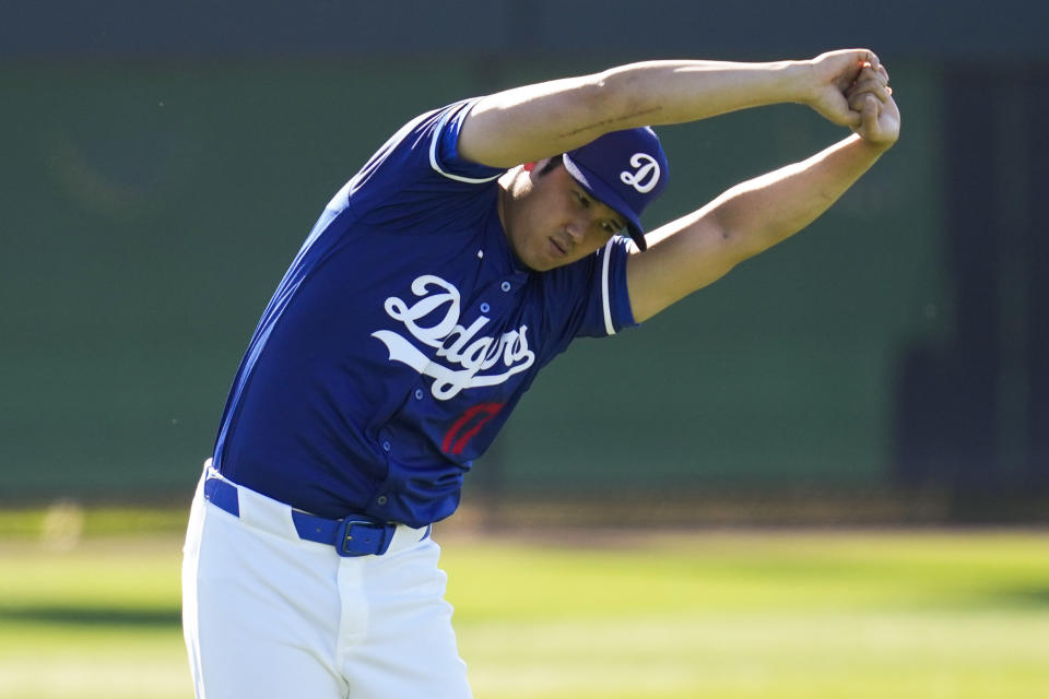 FILE - Los Angeles Dodgers designated hitter Shohei Ohtani participates in spring training baseball workouts at Camelback Ranch in Phoenix, Wednesday, Feb. 14, 2024. Ohtani has dodged questions about his second elbow surgery. He said at his introductory press conference with the Dodgers in December that this operation was “completely different from my first time, so I don't know what you want to call it. You could probably talk to my doctor about that.”(AP Photo/Ashley Landis, File)