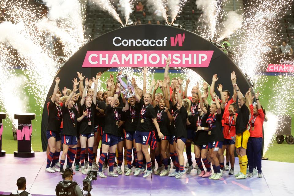 The USWNT receives the Concacaf championship trophy after defeating Canada.