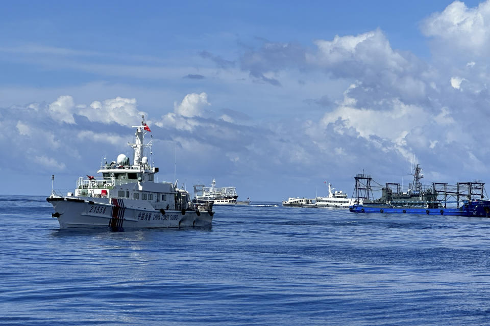 Chinese coast guard and suspected Chinese militia ship block the Philippine coast guard ship BRP Cabra as they approach Second Thomas Shoal, locally known as Ayungin Shoal, during a resupply mission at the disputed South China Sea on Friday Nov. 10, 2023. (AP Photo/Joeal Calupitan)