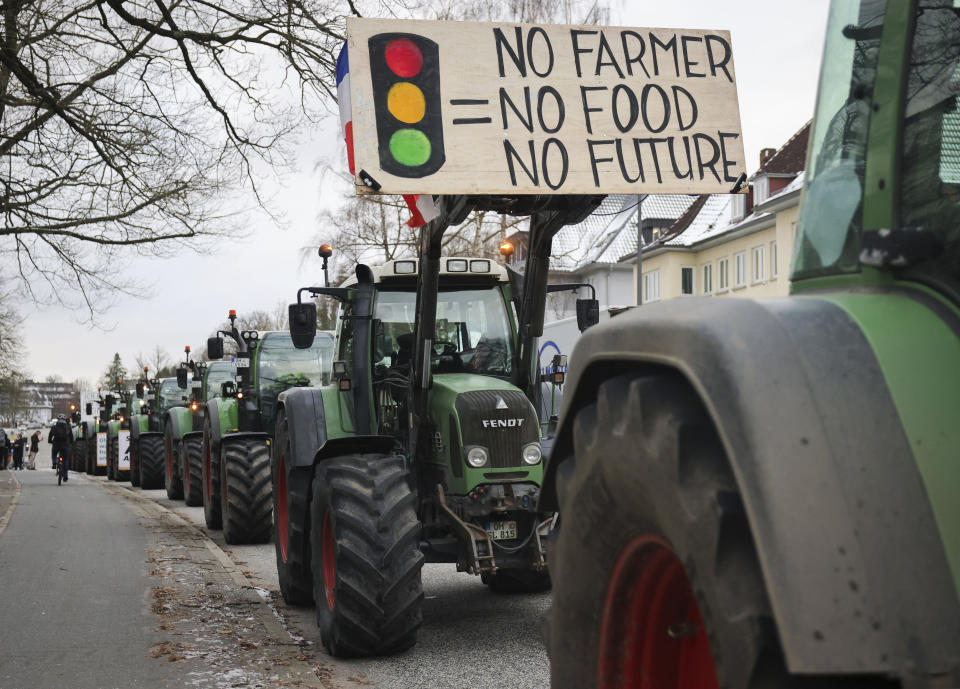 Farmers demonstrate with their tractors in front of the state parliament in Kiel, Germany, Monday, Jan. 8, 2024. Farmers blocked highway access roads in parts of Germany Monday and gathered for demonstrations, launching a week of protests against a government plan to scrap tax breaks on diesel used in agriculture. (Christian Charisius/dpa via AP)