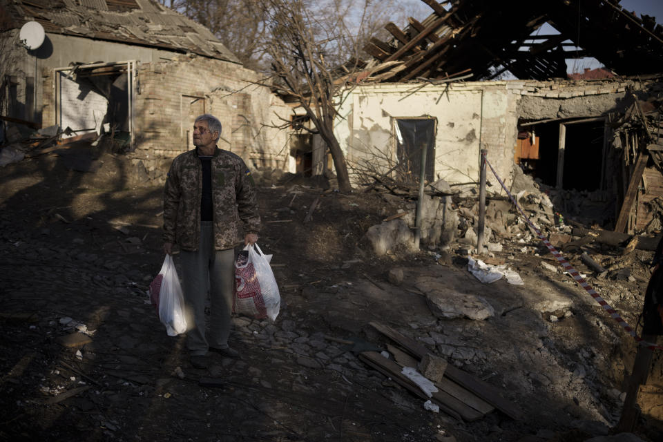 Anatolii Kaharlytskyi, 73, stands near his house, heavily damaged after a Russian attack in Kyiv, Ukraine, Monday, Jan. 2, 2023. Kaharlytskyi was injured and his daughter in law Iryna died in the attack on Dec. 31, 2022. (AP Photo/Renata Brito)