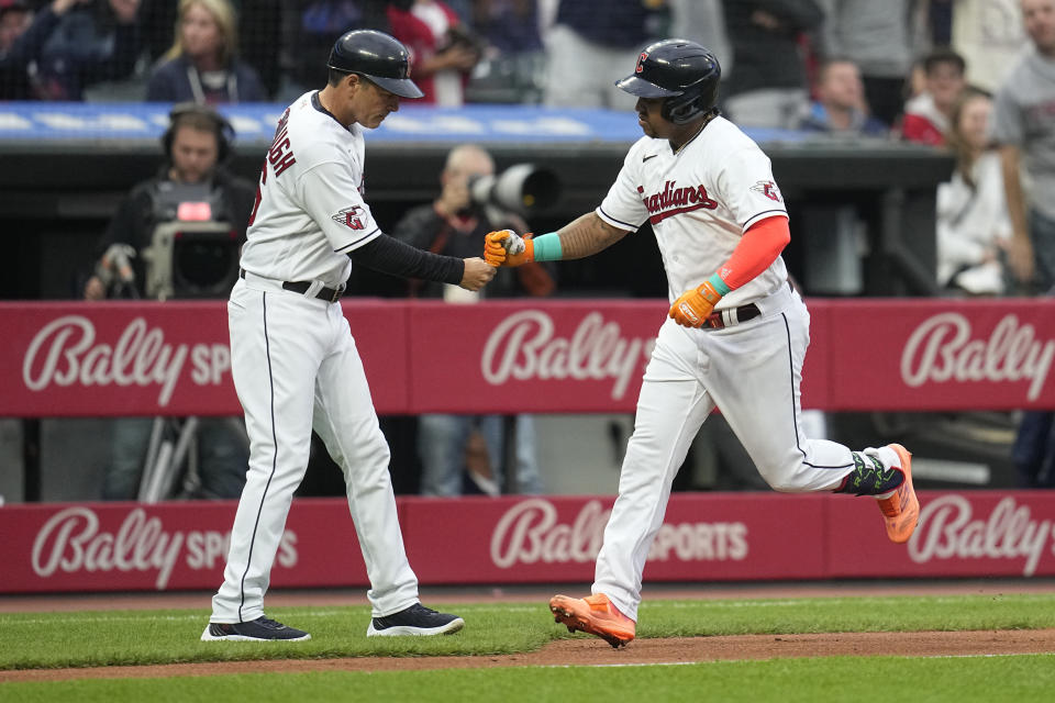 Cleveland Guardians' Jose Ramirez fist-bumps third base coach Mike Sarbaugh after his home run against the Boston Red Sox during the third inning of a baseball game Thursday, June 8, 2023, in Cleveland. It was Ramirez's 200th career home run. (AP Photo/Sue Ogrocki)