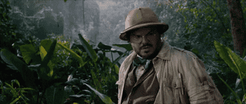 Jack Black, as his character from Jumanji, looks around bewildered in the jungle setting